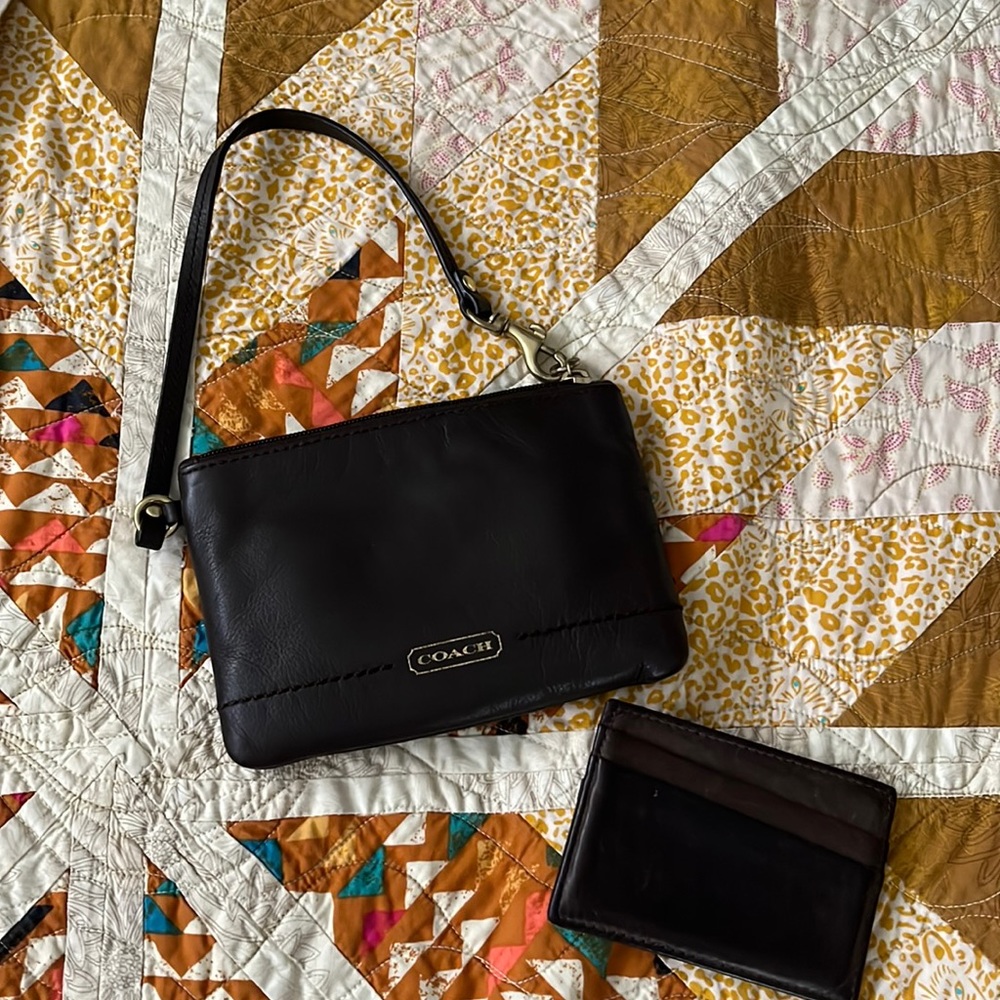 Dark brown Coach corner zip wristlet.